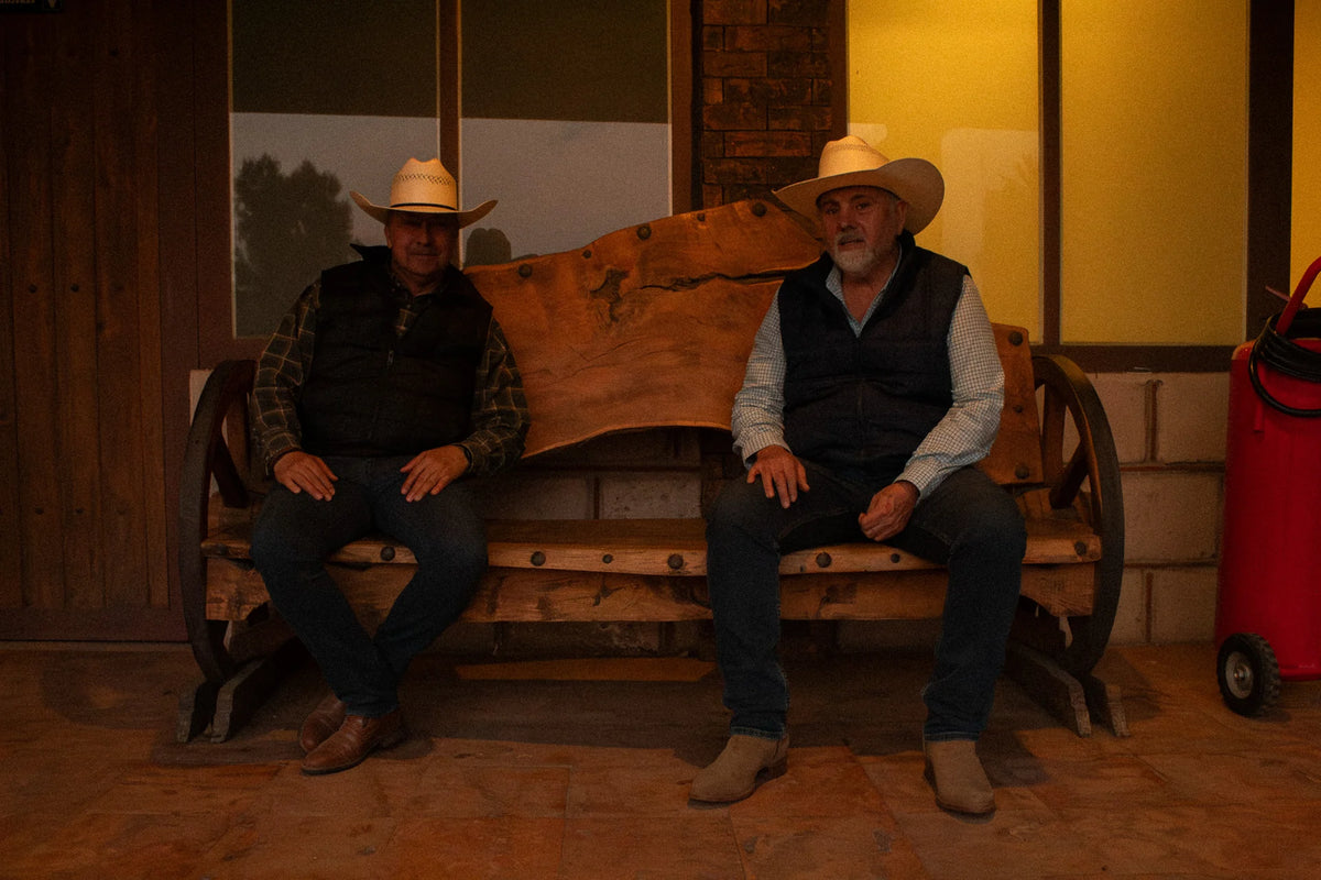 Dos hombres con sombreros Goose Western en el rancho